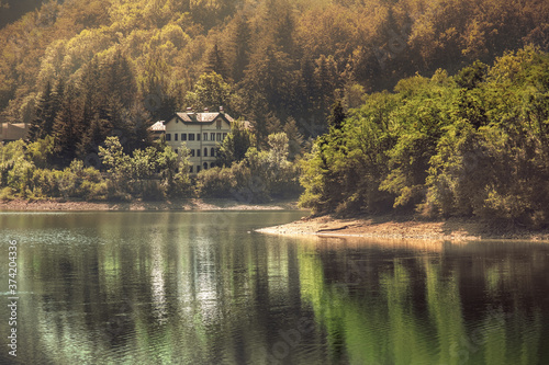 autumn lake warm tones view building with reflections on water photo