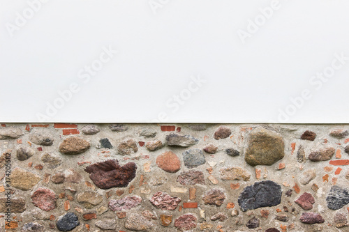 Combination of two horizontal textured - white plaster and rough brick stane wall. Photo with copy blank space. photo