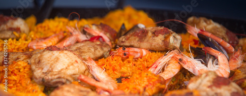 Large photo of paella with shrimp rice roasted chicken and mussels