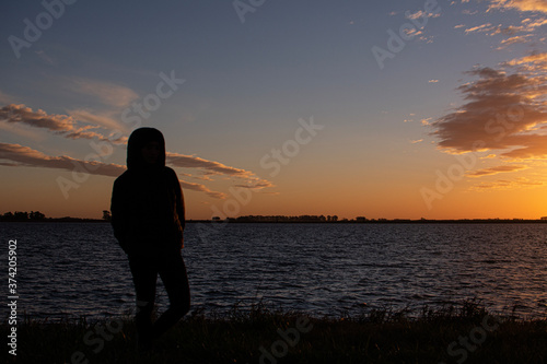 Girl See Sunset Over the Lake