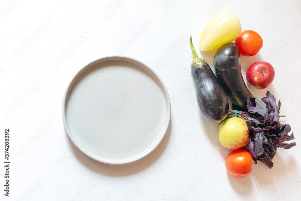 vegan grocery products with plate on white background. fresh healthy vegetables concept vegan grocery products with plate on white background. fresh healthy vegetables concept