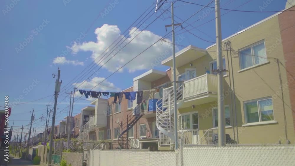 Montreal, Canada - April 10, 2018: Driving through duplex houses in Ahuntsic, district in the northern part of Montreal, Quebec, Canada Montreal, Canada - April 10, 2018: Driving through duplex houses in Ahuntsic, district in the northern part of Montreal, Quebec, Canada