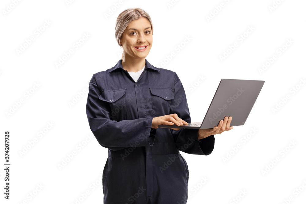 Female worker in a navy blue overall uniform with a laptop computer Female worker in a navy blue overall uniform with a laptop computer