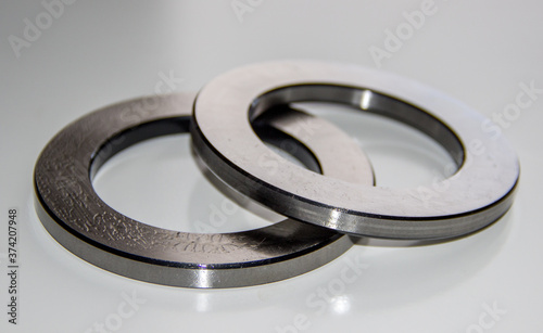 Two outer rings for a thrust roller bearing greased in bearing lubricant with selective focus