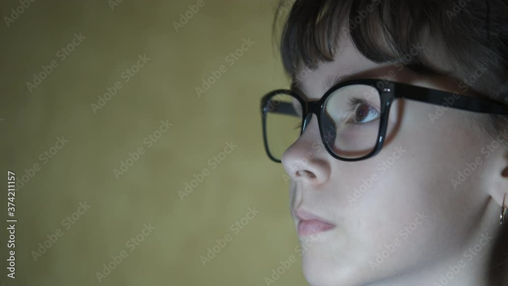 Portrait of a girl looking at a monitor screen. Portrait of a girl looking at a monitor screen.