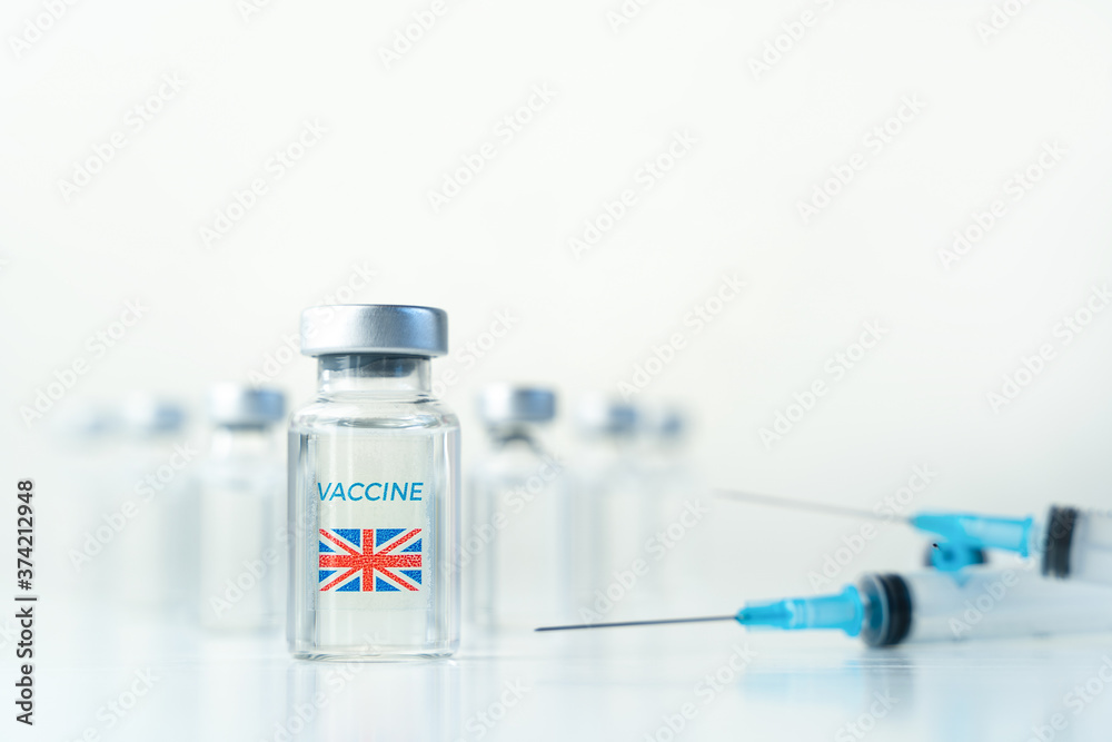 Transparent vials with UK flag. Vaccine, syringes for covid-19 coronavirus, flu, infectious diseases.Injection after clinical trials for vaccination of human,child,adult,senior.Medicine, drug concept