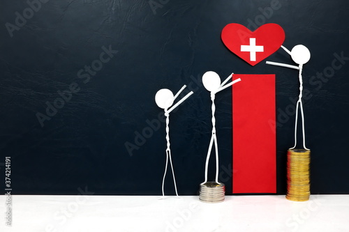 Stick figure reaching for a red heart shape with cross cutout while stepping on stack of coins. Healthcare, medical care and hospital access inequality concept.