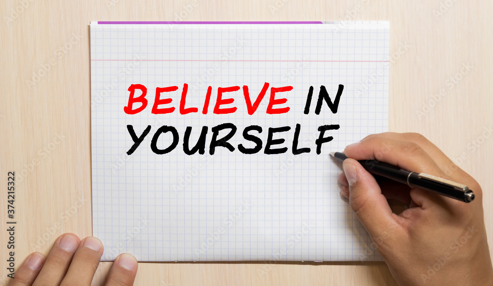 Believe in yourself. word written on a sticky note on the gray fridge