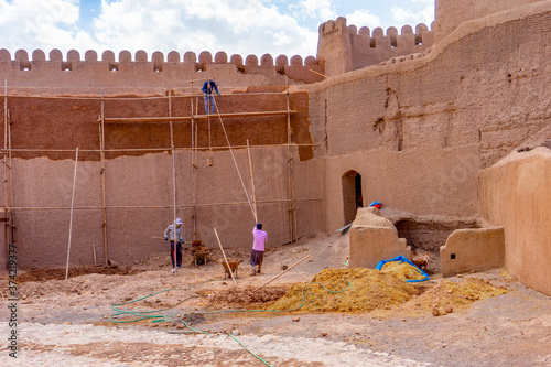 In Central Iran, inside the Castle's ruins of Rayan. District of Kerman. Workers are restoring the old castle after an earthquake. photo