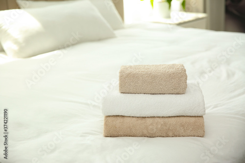 Soft clean towels on bed at home © New Africa