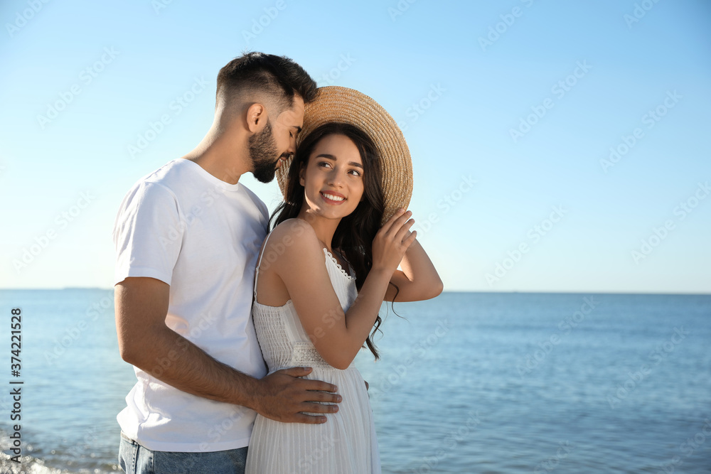 Happy young couple at beach. Honeymoon trip Happy young couple at beach. Honeymoon trip