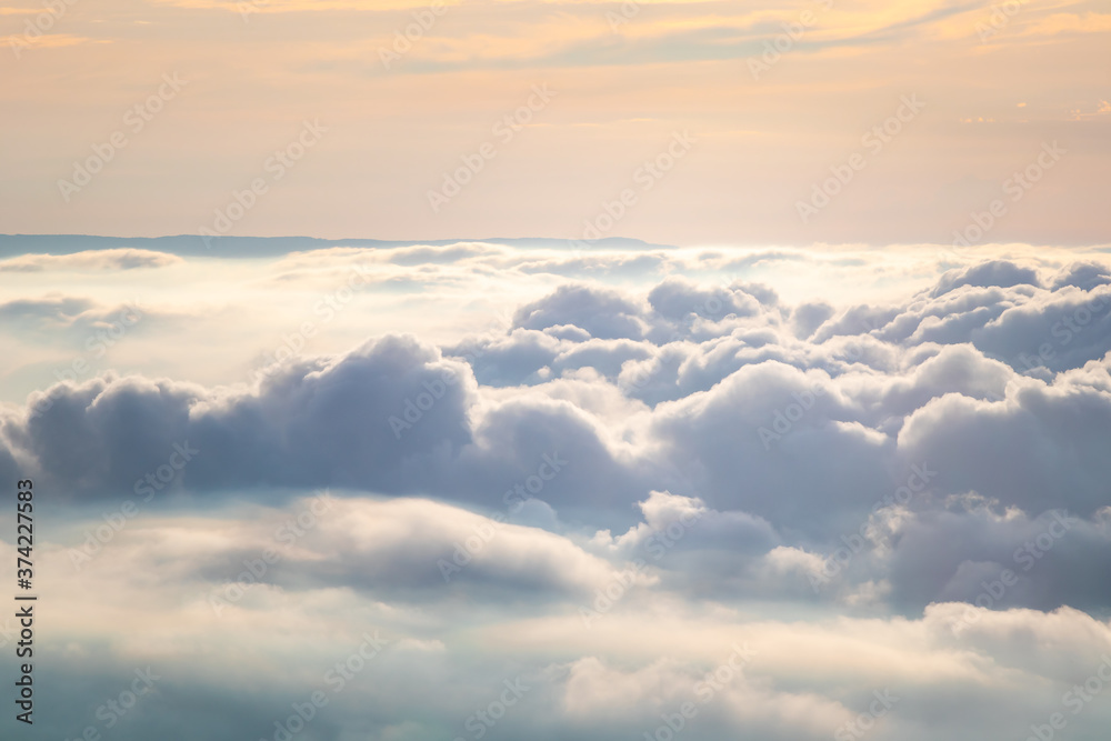 View at sunrise with puffy foggy. White puffy like cloud stretching to foggy horizon in the bright morning. View at sunrise with puffy foggy. White puffy like cloud stretching to foggy horizon in the bright morning.