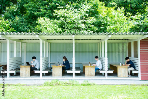 Men and woman are Working on an Outdoor Office that Set Social Distancing as New Normal Office Style photo