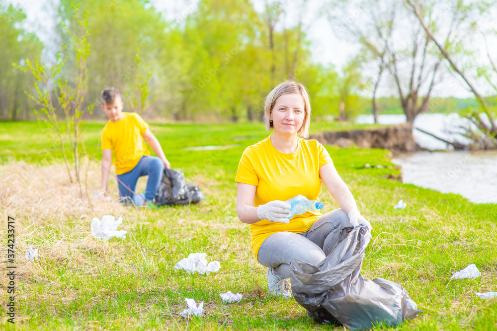 Fototapeta premium Volunteers clear the park from garbage. Volunteer and ecology concept