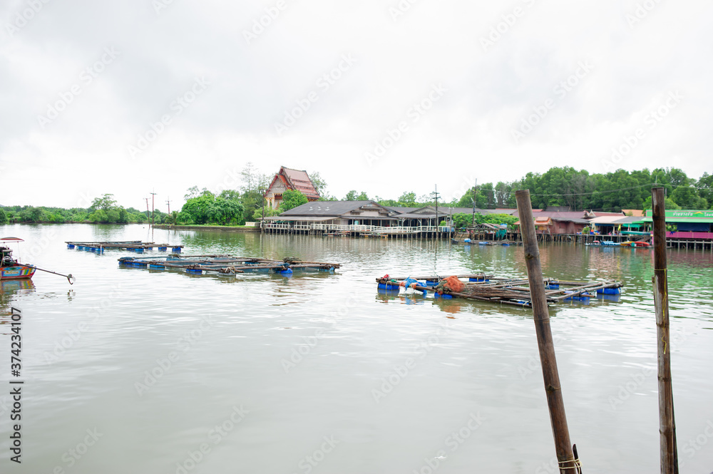 Fototapeta premium Fishing cages and boats in fishing villages