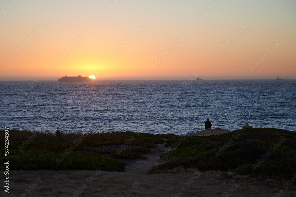 Ship passing in front of the setting sun