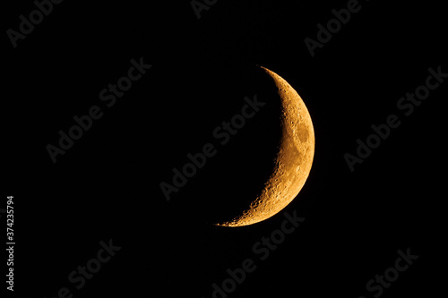 Orange colored waxing crescent moon; the orange glow is the result of the smoke coming from the wildfires burning all aver the San Francisco Bay Area, California