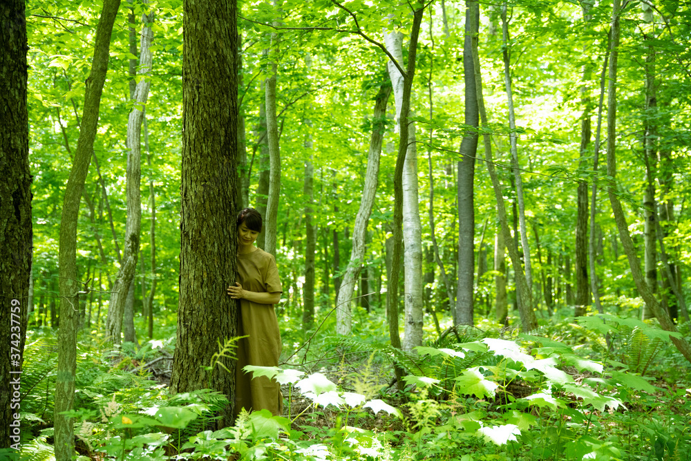 © imagenavi - Mature Woman Close to the Tree © imagenavi - Mature Woman Close to the Tree