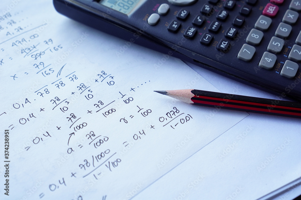 scientific math workout. sheet paper with solving equation math next to calculator scientific math workout. sheet paper with solving equation math next to calculator