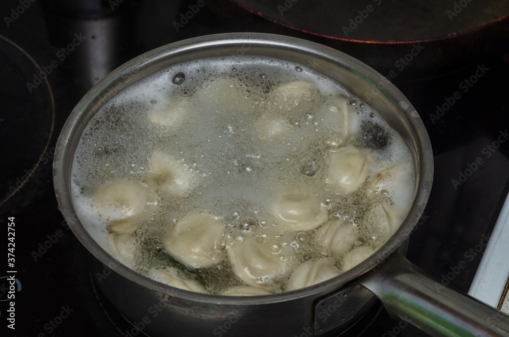 Russian food dumplings are cooked in a saucepan Russian food dumplings are cooked in a saucepan