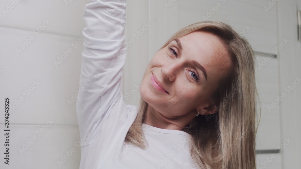 Close up of Elegant young woman looking at the camera in bathroom Close up of Elegant young woman looking at the camera in bathroom