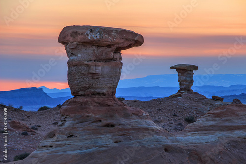 Two similar hoodoos sit opposite at sunset near the San Rafael Reef in Utah. photo