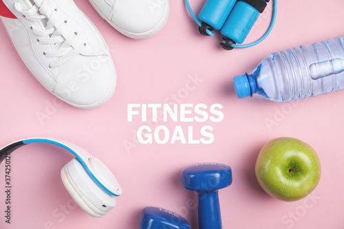 Fitness goals. Fitness equipment. Dumbbells, apple, sneakers, water bottle
