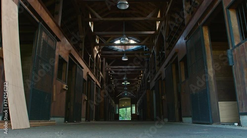 Low angle interior of unfinished horse stables under construction
