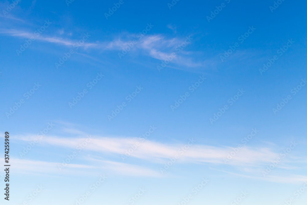 Blue sky with windy thin cirrus clouds at daytime