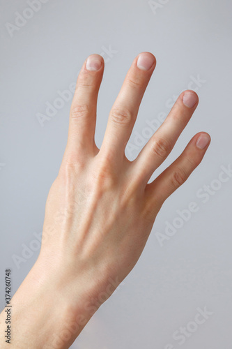 Man hand shows the number four. Countdown gesture or sign. Sign language. © Alexandra Selivanova