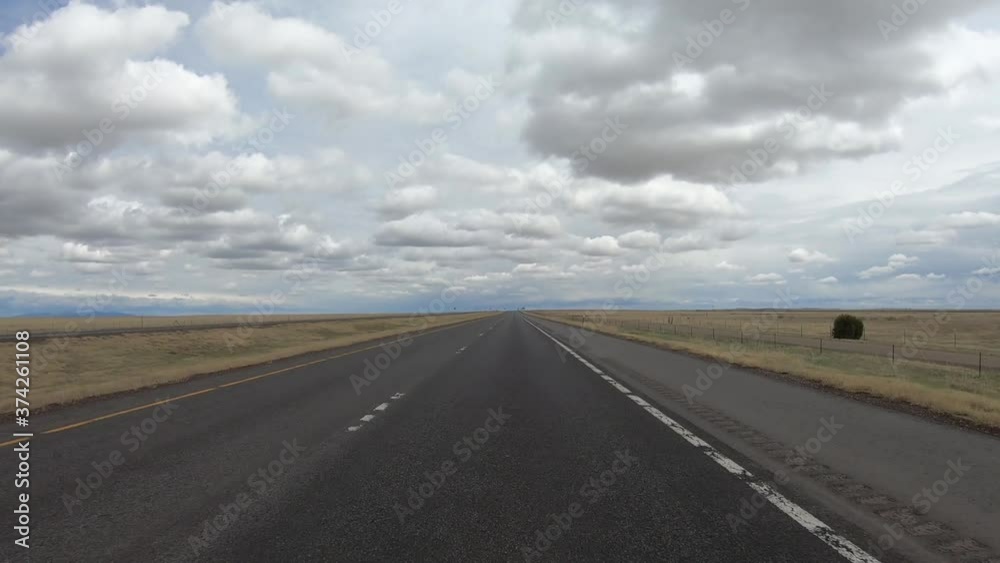 Timelapse of Driving in American Countryside on Empty Freeway Under Cloudy Sky. Traveling During Covid-19 Virus Outbreak, Driver POV Timelapse of Driving in American Countryside on Empty Freeway Under Cloudy Sky. Traveling During Covid-19 Virus Outbreak, Driver POV