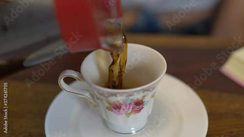 Close up of Coffee pouring in a Cup - Goldy photo