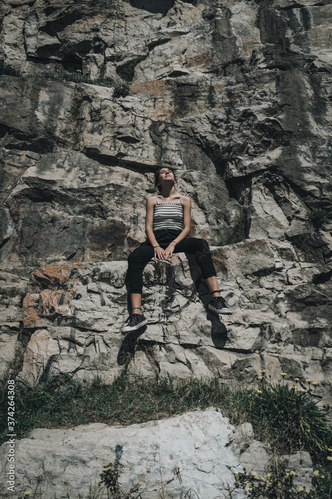 girl sitting on the mountain, adventure travel concept, trekking campaign, hiking advertising social media copy space 