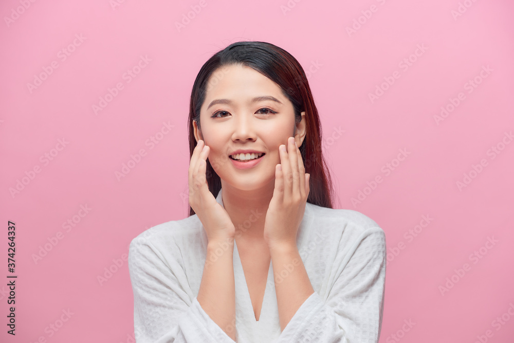 Portrait of beautiful woman with natural make up touching her face Portrait of beautiful woman with natural make up touching her face