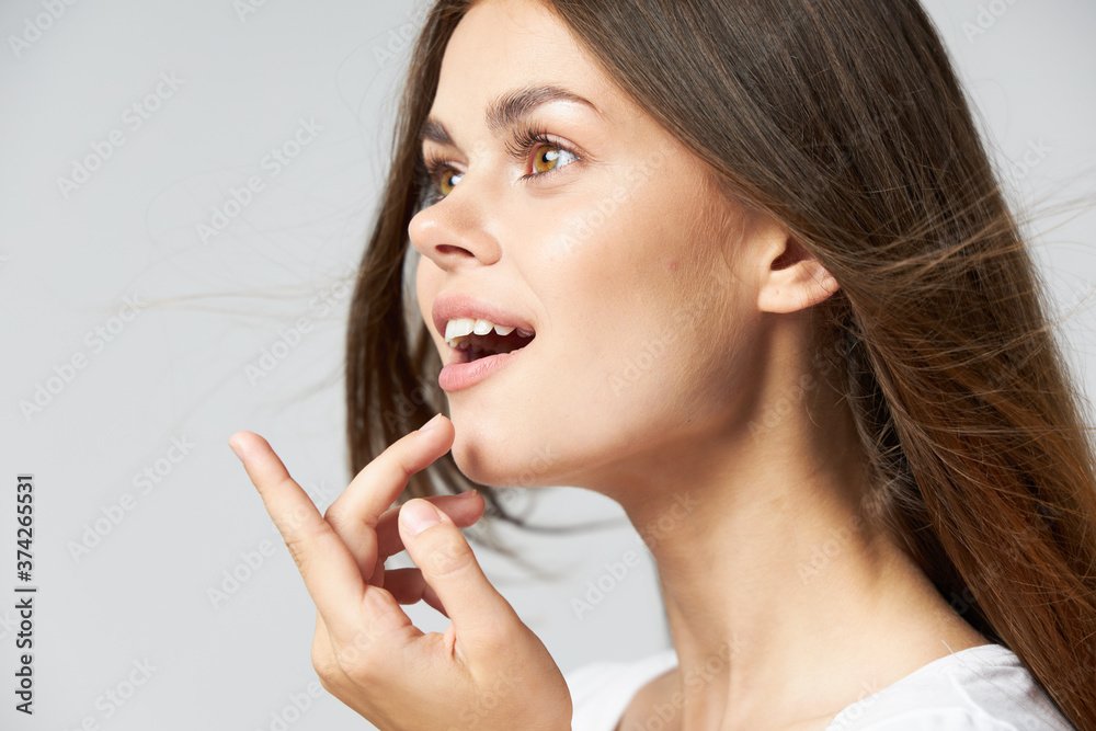 Surprised woman with open mouth looks to the side showing thumb up Surprised woman with open mouth looks to the side showing thumb up