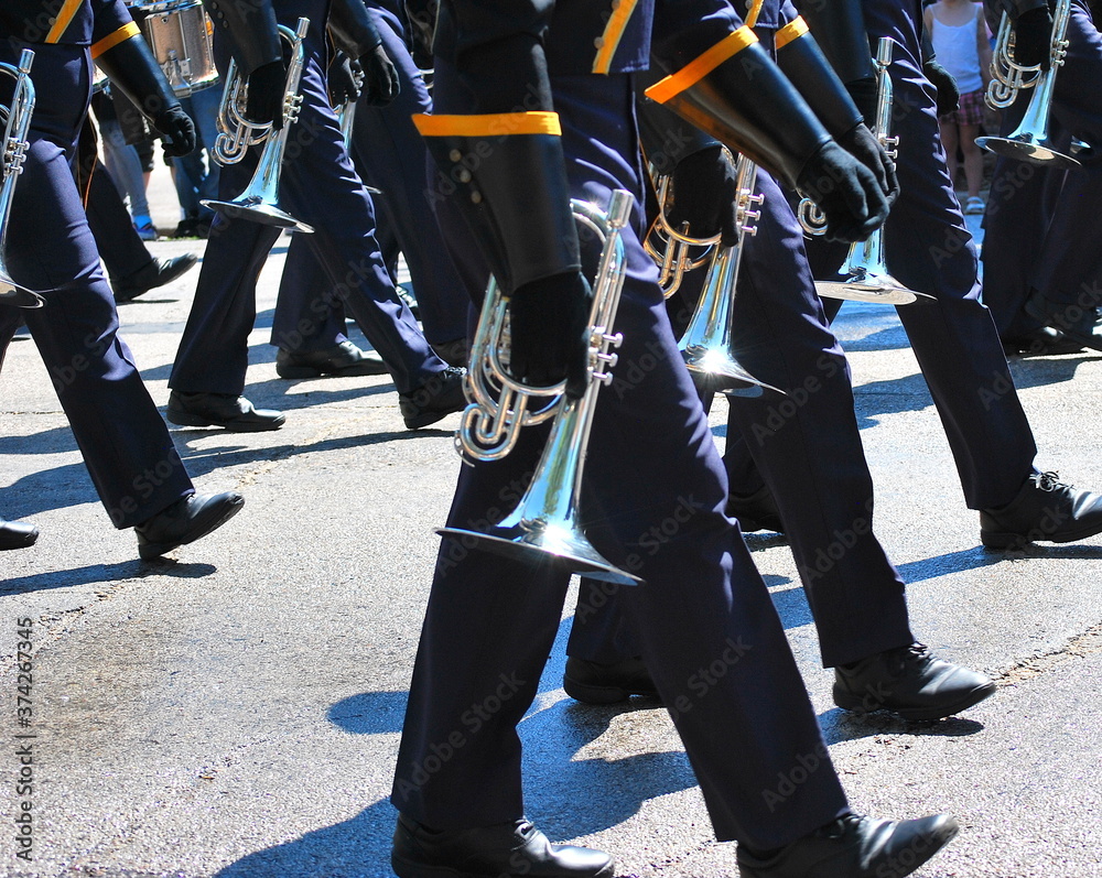 Marching band in a parade outdoors.