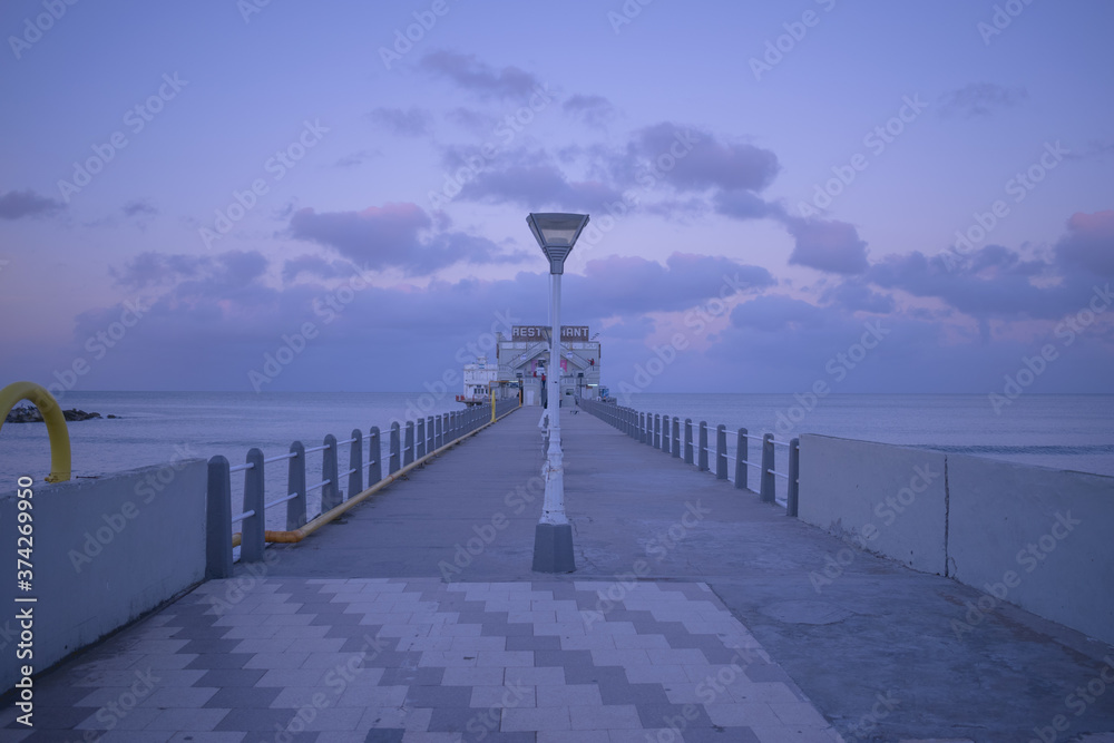 bridge with pink and purple sky, background sea and clouds, travel concept, vacation campaign, summer advertising