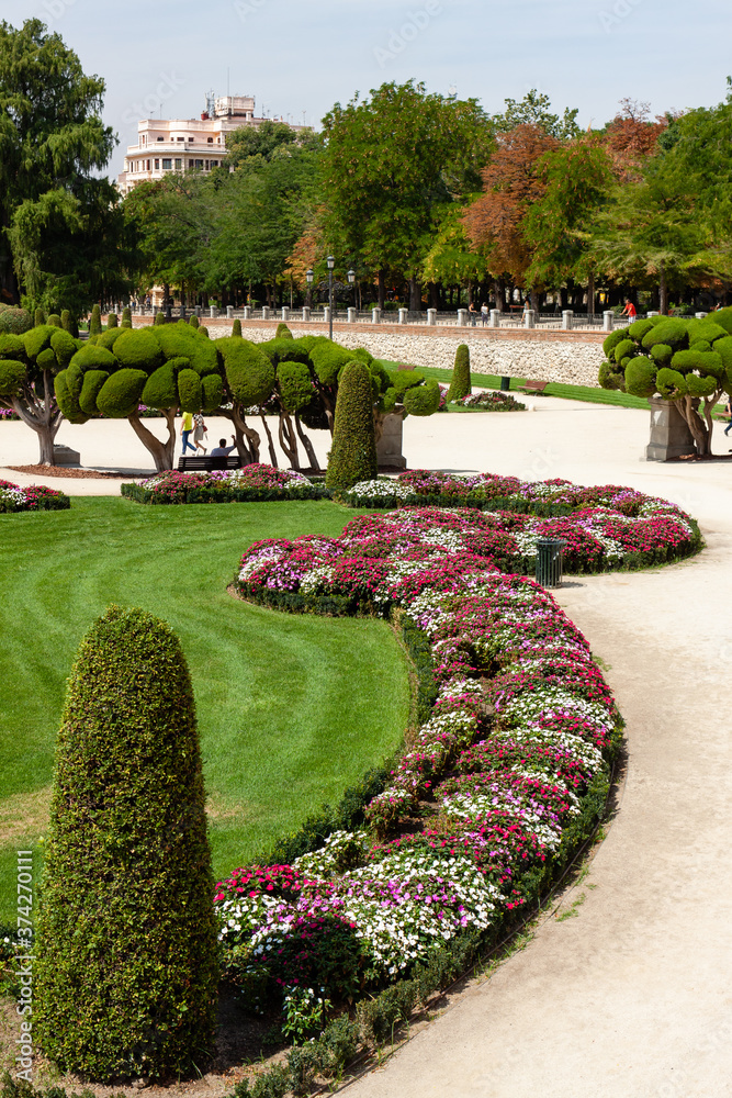 Beautiful Park with a lot of green trees and bushes in Madrid, Span in September during the sunny day