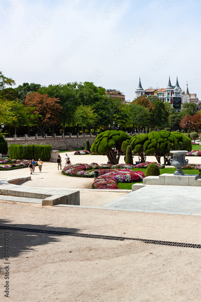 Beautiful Park with a lot of green trees and bushes in Madrid, Span in September during the sunny day