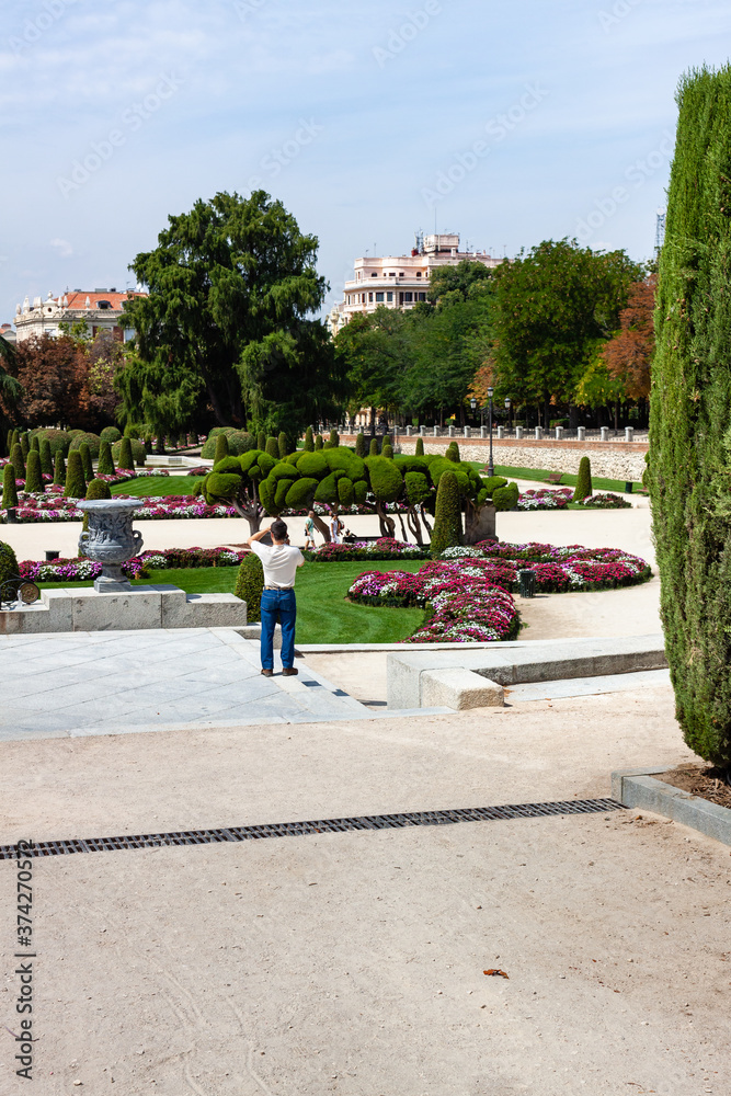 Beautiful Park with a lot of green trees and bushes in Madrid, Span in September during the sunny day