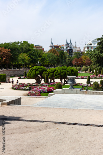 Beautiful Park with a lot of green trees and bushes in Madrid, Span in September during the sunny day