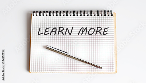 Wallpaper Mural Handwriting text LEARN MORE on the notepad on white background Torontodigital.ca