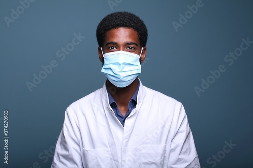 Beautiful afro doctor in front of a background