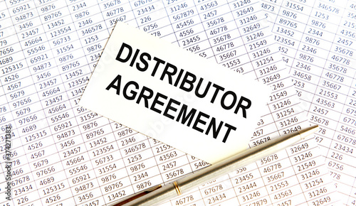 The inscription on the CARD DISTRIBUTOR AGREEMENT, next to the book, pen, account. A business concept.