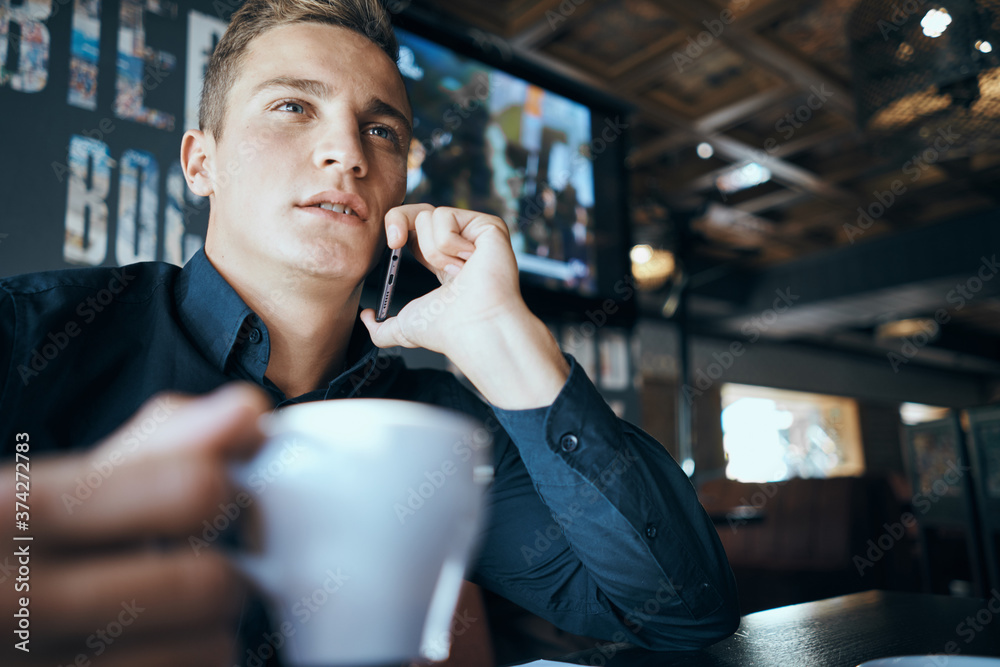 Business man with a cup of coffee in a cafe emotions work in the office stress irritability director Business man with a cup of coffee in a cafe emotions work in the office stress irritability director