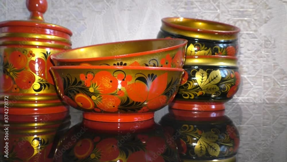 Bright wooden kitchen utensils. Khokhloma is an ancient Russian folk craft of the XVII century. Traditional elements of Khokhloma are red juicy berries of mountain ash and strawberries. Bright wooden kitchen utensils. Khokhloma is an ancient Russian folk craft of the XVII century. Traditional elements of Khokhloma are red juicy berries of mountain ash and strawberries.