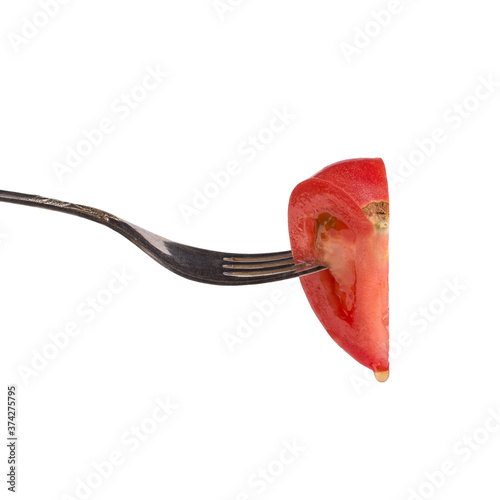 Red tomato on a fork, harvesting design isolate on a white background.