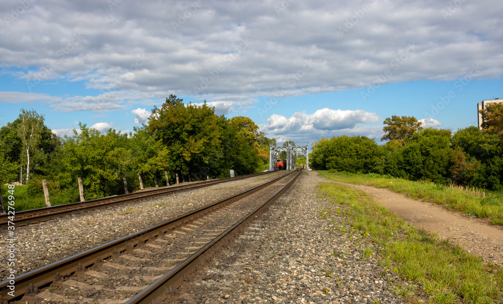 Obraz premium On the railway bridge is a locomotive.
