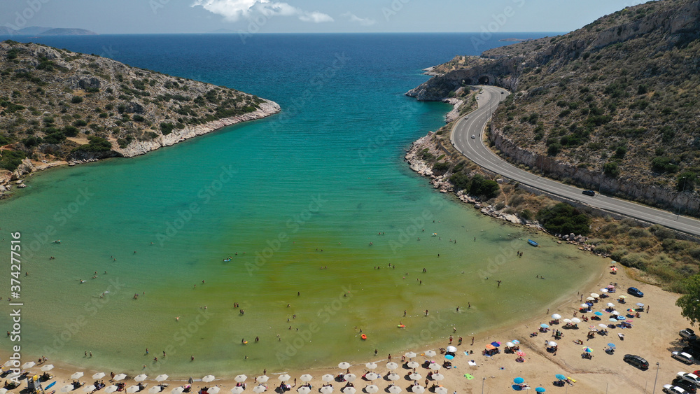 Aerial drone photo of small protected by winds cove and sandy beach of Lomvarda in Athens riviera next to Hole of Karamanlis tunnel, Vouliagmeni, Attica, Greece