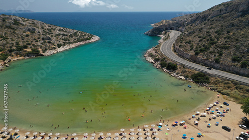 Aerial drone photo of small protected by winds cove and sandy beach of Lomvarda in Athens riviera next to Hole of Karamanlis tunnel  Vouliagmeni  Attica  Greece